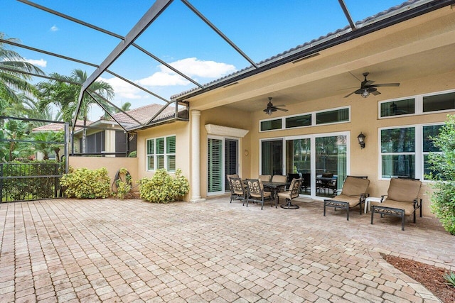 view of patio featuring ceiling fan and a lanai