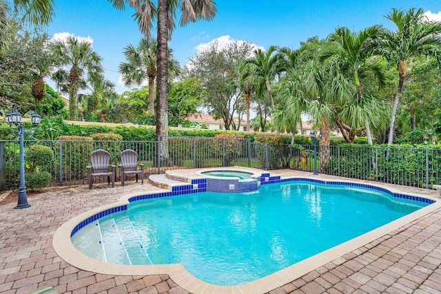 view of pool with an in ground hot tub and a patio