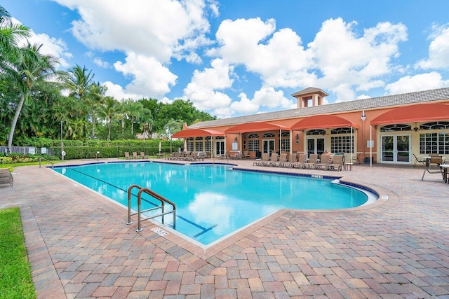 view of pool with ceiling fan and a patio