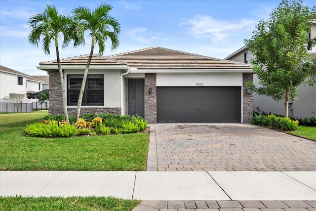 view of front of house with a garage and a front lawn