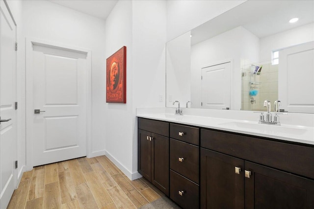 bathroom with vanity, an enclosed shower, and hardwood / wood-style flooring