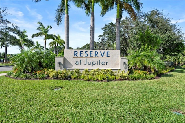 community sign featuring a lawn