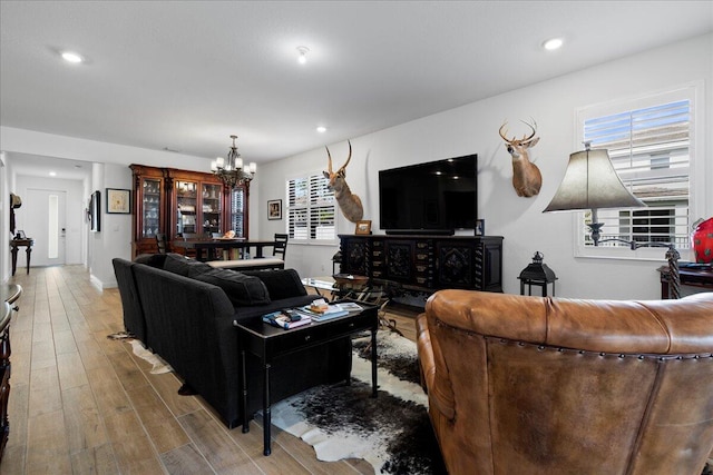 living room with hardwood / wood-style flooring and a chandelier