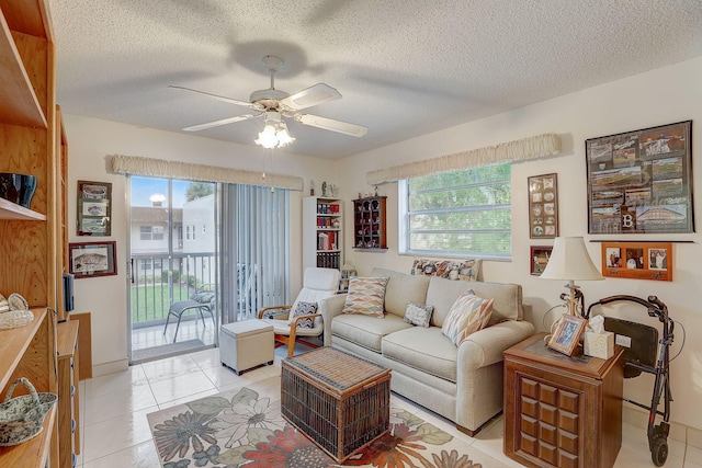 living room with a textured ceiling, a healthy amount of sunlight, and light tile patterned floors