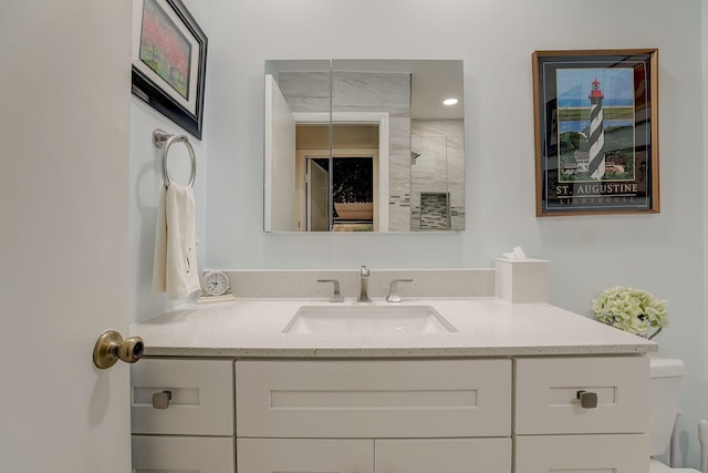 bathroom featuring walk in shower and vanity