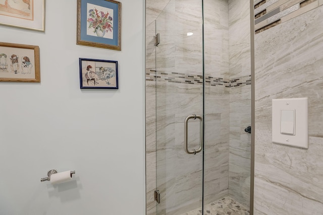 bathroom with a shower with shower door