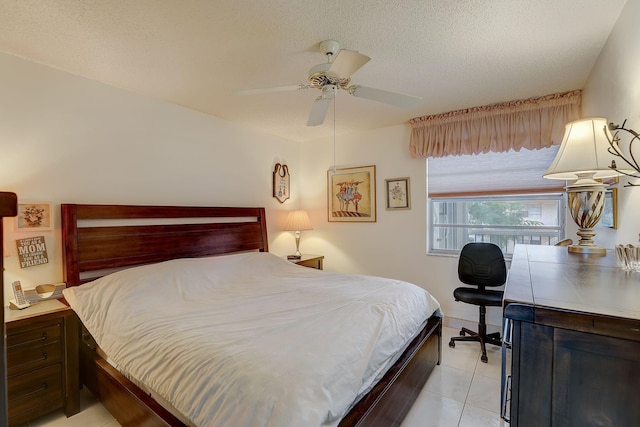 bedroom featuring a textured ceiling, ceiling fan, and light tile patterned floors