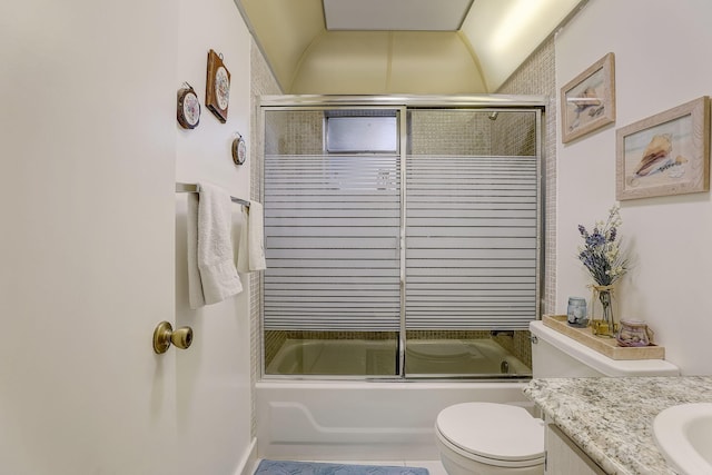 full bathroom with shower / bath combination with glass door, tile patterned floors, toilet, and vanity