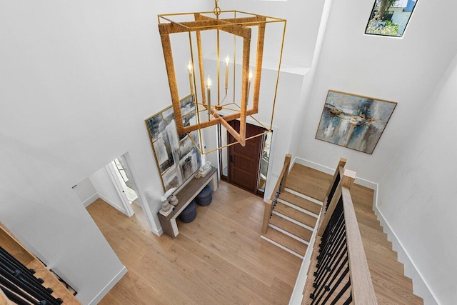 bedroom with recessed lighting, a tray ceiling, and wood finished floors