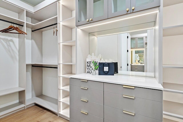 full bath featuring double vanity, a sink, and baseboards