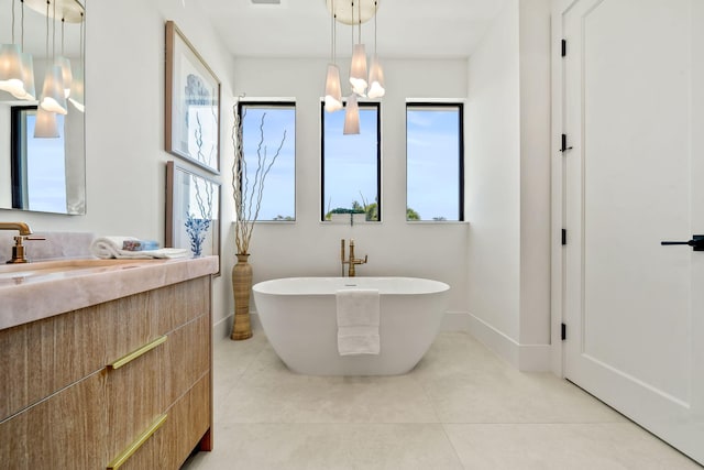 full bathroom featuring double vanity, a stall shower, a sink, baseboards, and a closet