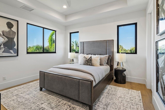 bedroom with recessed lighting, baseboards, light wood finished floors, and visible vents