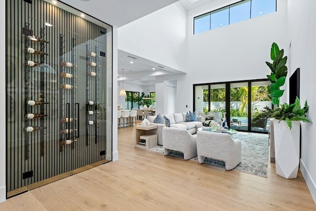 living area featuring a healthy amount of sunlight, a high ceiling, and visible vents