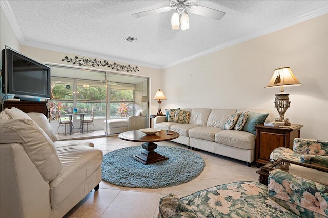 living room with ornamental molding, a textured ceiling, light tile patterned floors, and ceiling fan