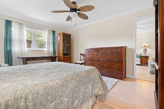 bedroom featuring light wood-type flooring, a textured ceiling, ceiling fan, and crown molding