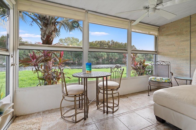 sunroom / solarium featuring a wealth of natural light and ceiling fan