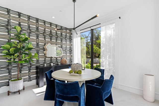 dining space featuring concrete flooring