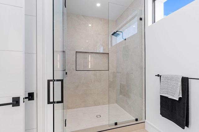 bathroom featuring a shower with shower door