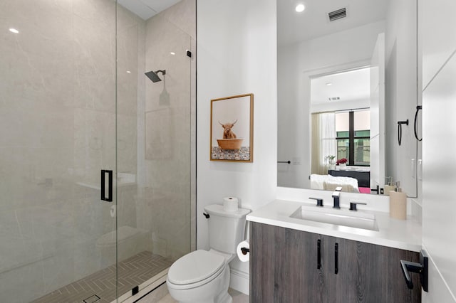 bathroom with vanity, toilet, and an enclosed shower