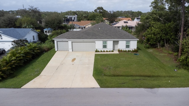 view of front facade with a garage and a front lawn