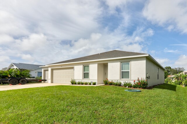 ranch-style house featuring a garage and a front lawn