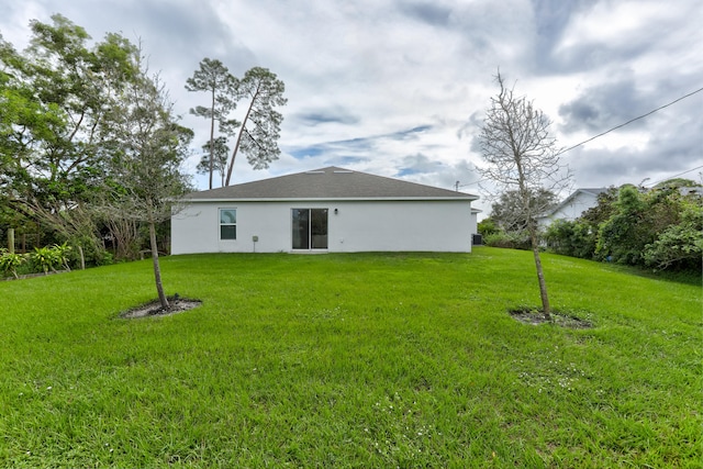 back of house featuring a yard