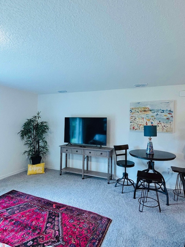 living room with carpet floors and a textured ceiling