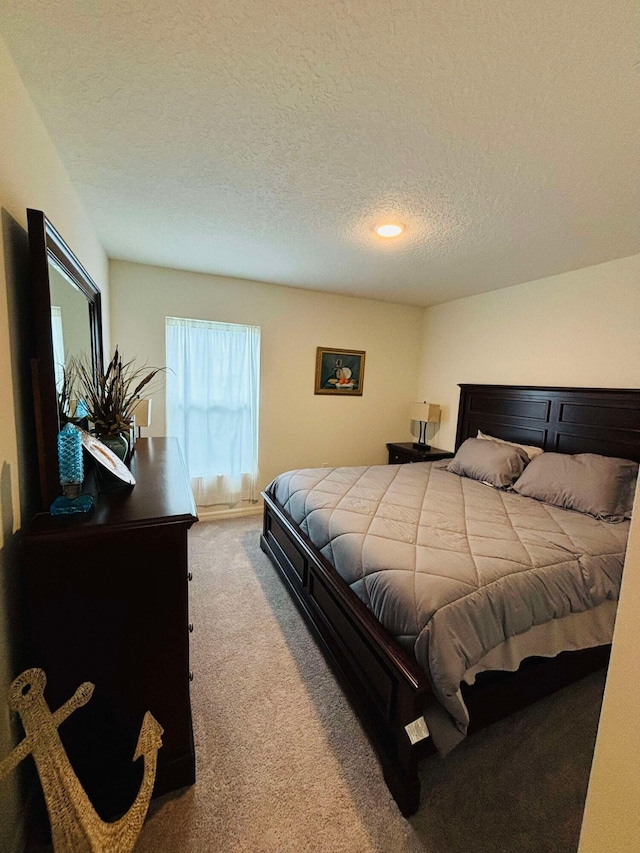 carpeted bedroom with a textured ceiling