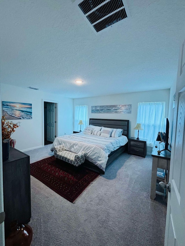 carpeted bedroom featuring a textured ceiling