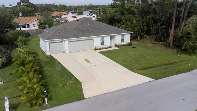 view of front of property with a front lawn and a garage