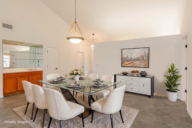 carpeted empty room featuring high vaulted ceiling and ceiling fan