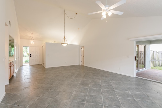 unfurnished room with tile patterned flooring, sink, and high vaulted ceiling