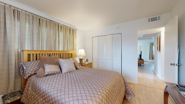 bedroom featuring a closet and light wood-type flooring