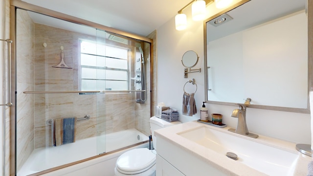 full bathroom with toilet, vanity, and enclosed tub / shower combo