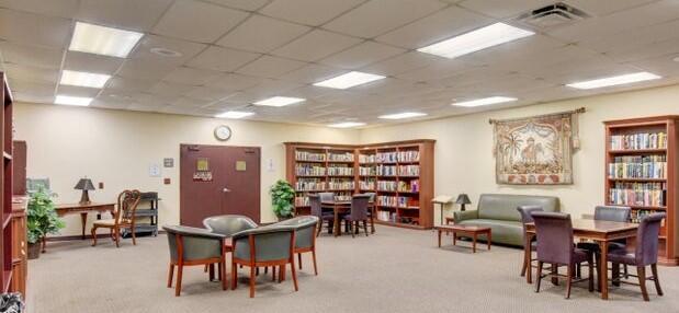 interior space featuring a paneled ceiling and light carpet