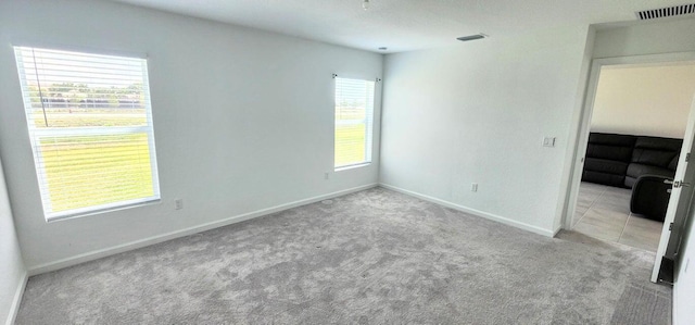 unfurnished room with light colored carpet