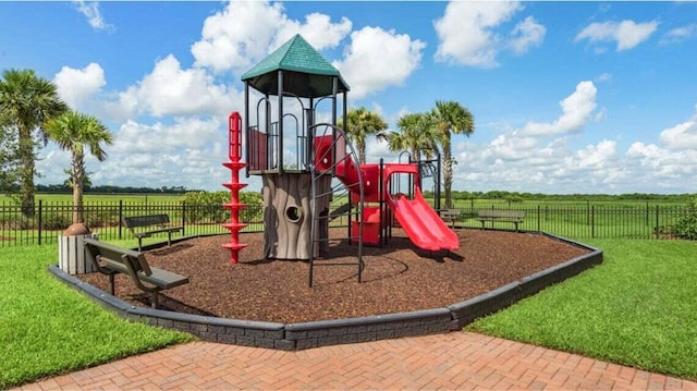 view of playground with a lawn