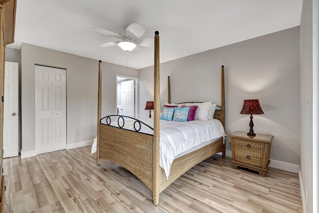 bedroom featuring ceiling fan, a closet, and light wood-type flooring