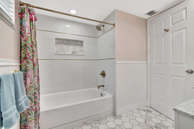 bathroom featuring shower / bath combo with shower curtain and tile patterned flooring