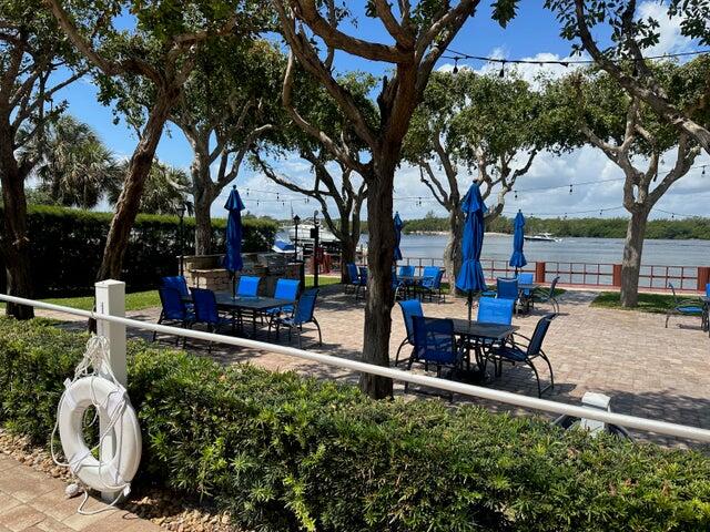 view of property's community with a water view and a patio area