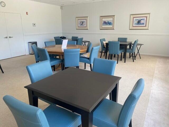 dining space featuring light colored carpet