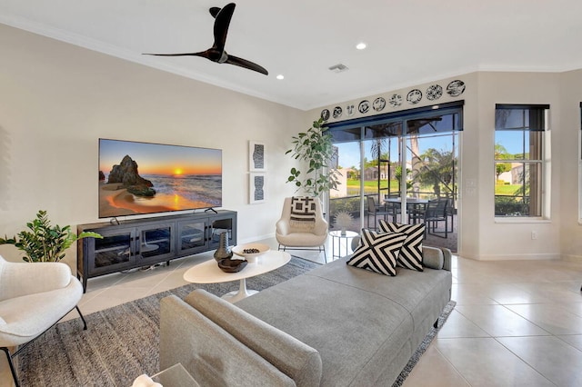 living room featuring ceiling fan, crown molding, and light tile patterned floors