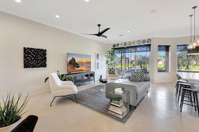 living room featuring light tile patterned floors, ceiling fan, and ornamental molding