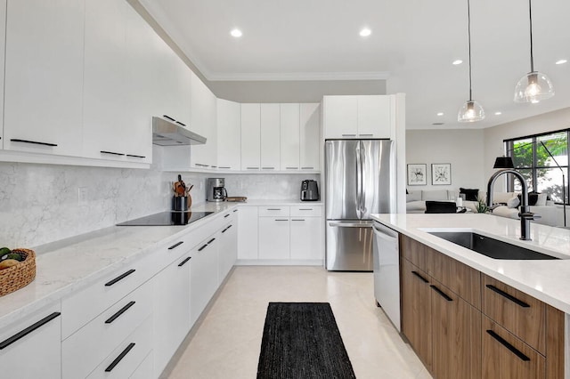 kitchen with white cabinets, stainless steel appliances, hanging light fixtures, and sink