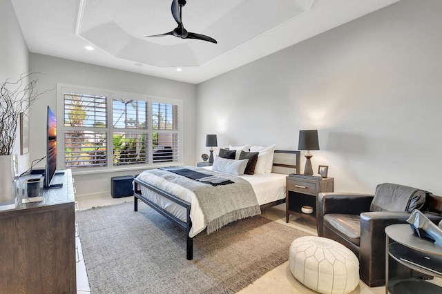 bedroom featuring a tray ceiling and ceiling fan