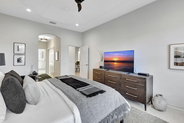 bedroom featuring ensuite bathroom, ceiling fan, and light tile patterned floors