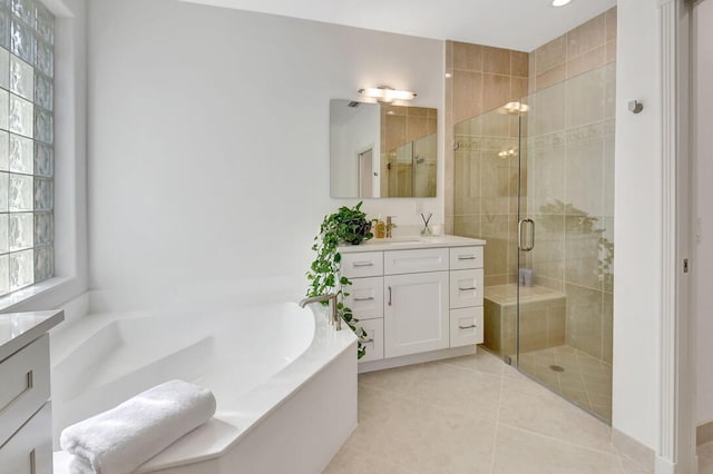 bathroom featuring vanity, independent shower and bath, tile patterned flooring, and plenty of natural light