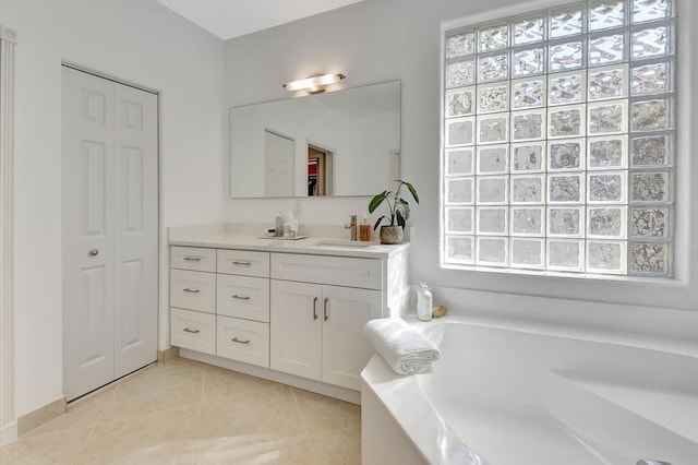 bathroom with tile patterned flooring, vanity, plenty of natural light, and a bathing tub