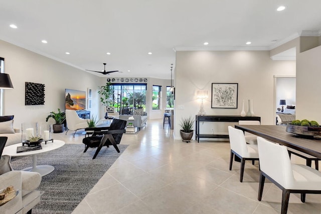 living room with crown molding, light tile patterned floors, and ceiling fan