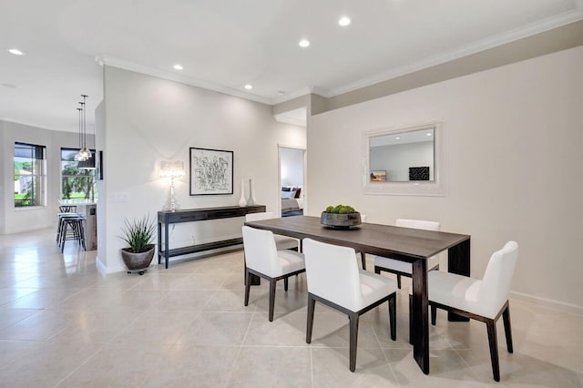 dining space featuring light tile patterned floors and ornamental molding